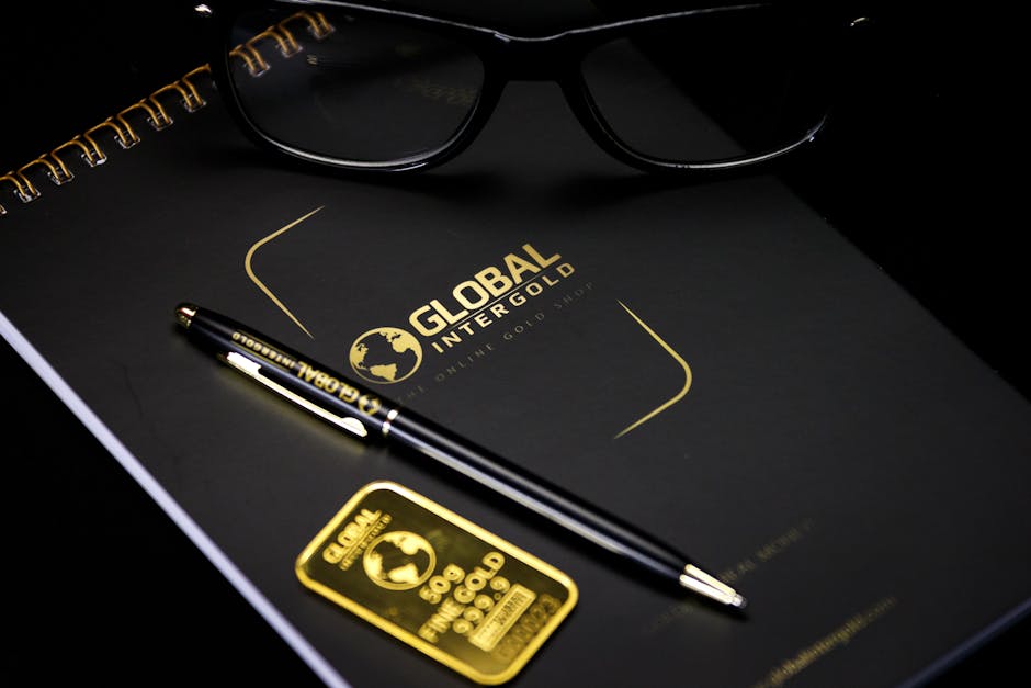 Home An elegant setup with a notebook, pen, and gold bar, embodying luxury and style.